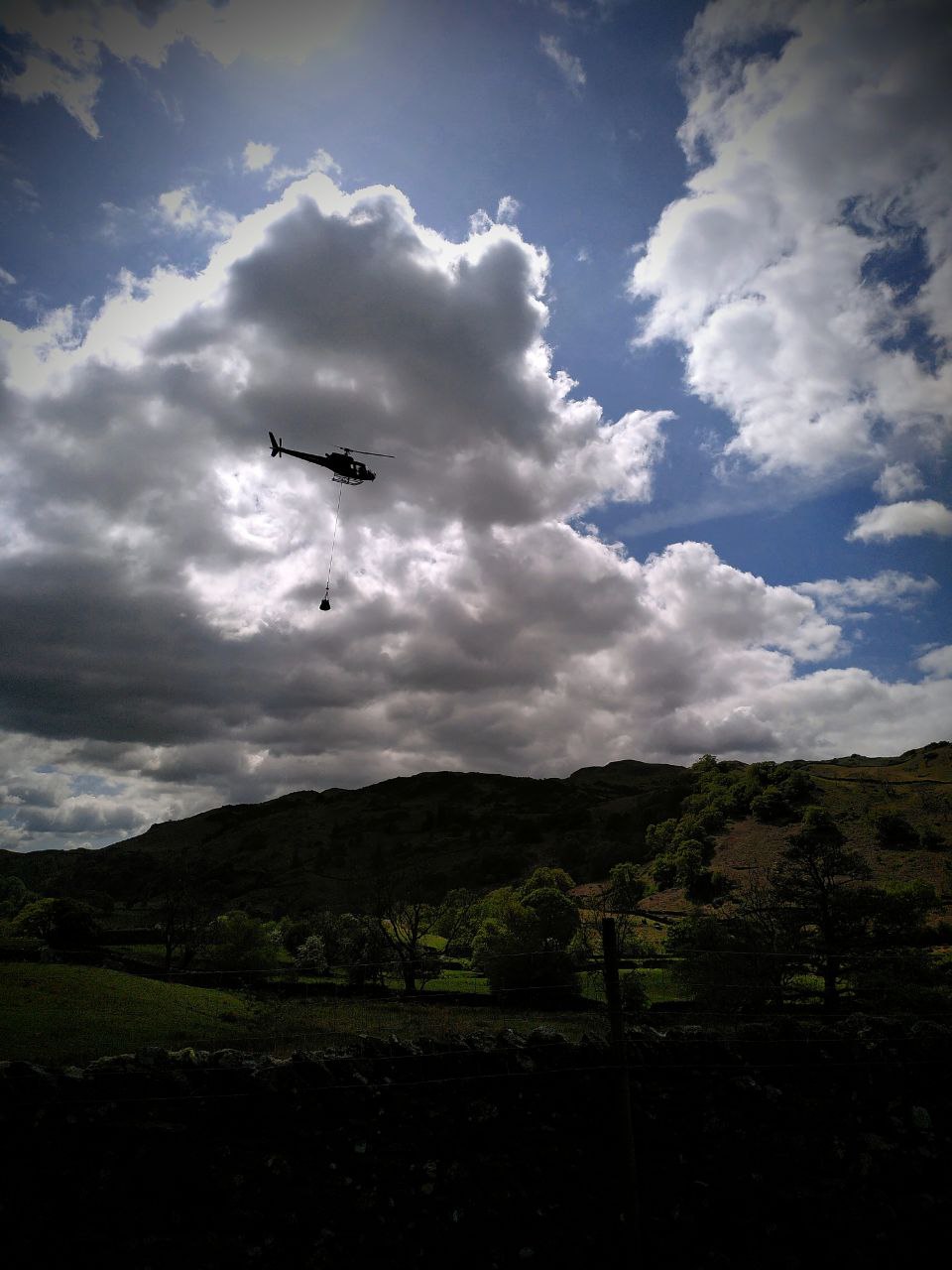 Helicopter lifting materials to repair footpaths